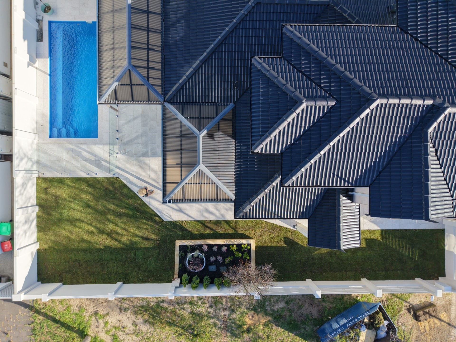Aerial view of a Perth home with finished poolside paving and lawn by Yardworks WA